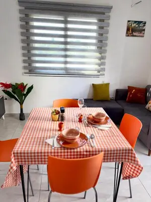 a dining room table with a red and white checkered table cloth at Orange Sunset Duplex Lapta 2 bedrooms close to Merit Casino in Meniko