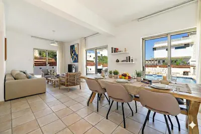 a large dining room with a table and chairs at Fig Tree Beach Villa One in Protaras