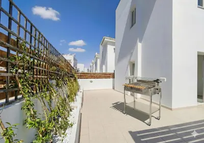a barbecue grill on the side of a building at Fig Tree Beach villa Three in Protaras