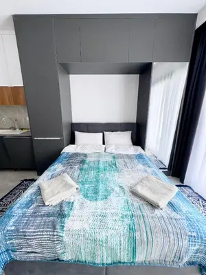 a bedroom with a large bed with two pillows on it at Riverside studio in Iskele in Dherinia