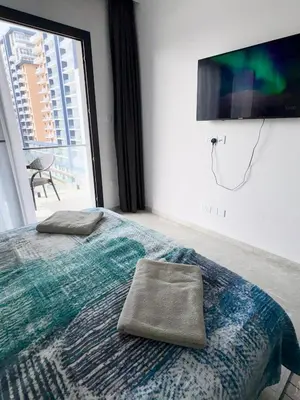 a bedroom with a bed with two pillows on it at Riverside studio in Iskele in Dherinia
