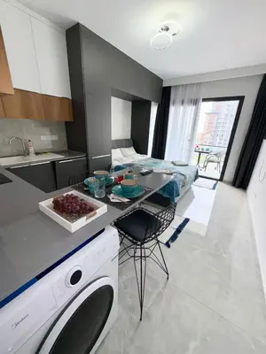 a kitchen with a table and a bed in a room at Riverside studio in Iskele in Dherinia