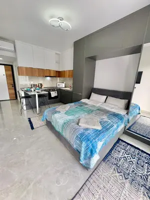 a bedroom with a large bed and a desk at Riverside studio in Iskele in Dherinia