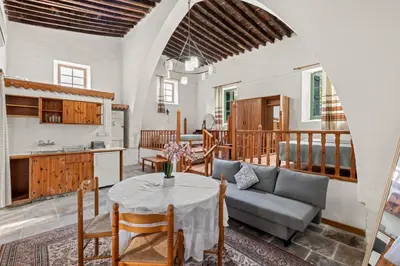a living room with a table and a couch at Antonys Garden House in Episkopi Lemesou