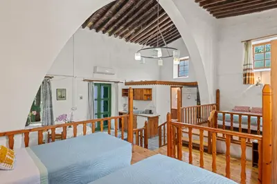 a room with two beds and a kitchen in it at Antonys Garden House in Episkopi Lemesou