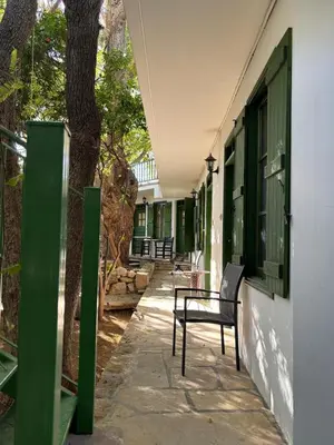 a patio with a table and a chair next to a building at Antonys Garden House in Episkopi Lemesou
