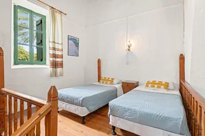 a bedroom with two beds and a window at Antonys Garden House in Episkopi Lemesou