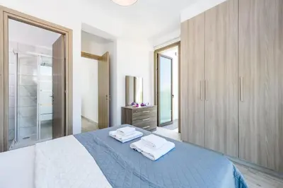 a bedroom with a bed with two towels on it at Villa Levanda #40 in Paralimni