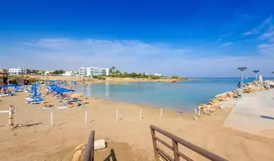 a beach with a bunch of people laying on the sand at Villa Levanda #40 in Paralimni