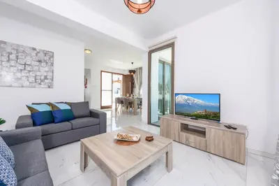 a living room with a couch and a tv at Villa Levanda #40 in Paralimni