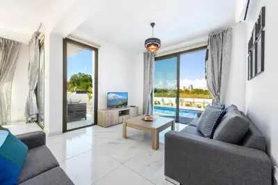 a living room with a couch and a table at Villa Levanda #40 in Paralimni