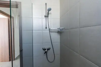 a shower with a shower head in a bathroom at White Pearl Villa Protaras 7 in Paralimni