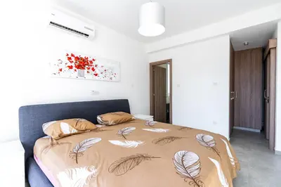 a bedroom with a bed with a blanket with feathers on it at White Pearl Villa Protaras 7 in Paralimni