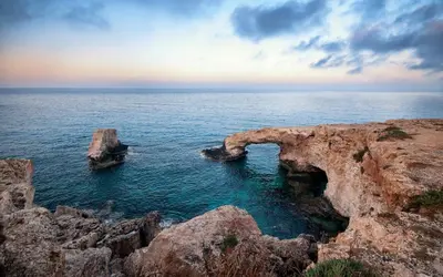 a cave in the ocean with rocks in the water at Fig Tree Beach Villa Five in Protaras
