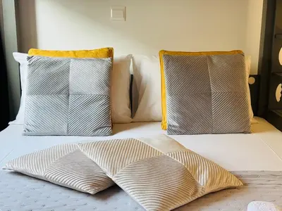 a bed with two pillows on top of it at Makenzie View Penthouse in Larnaka