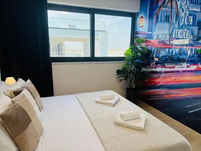 a bedroom with a bed with two towels on it at Makenzie View Penthouse in Larnaka