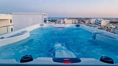 a swimming pool on top of a building at Makenzie View Penthouse in Larnaka