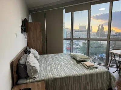 a bedroom with a bed with a view of a city at Room in EkinAdademir Dorm North Cyprus in Nicosia