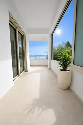 an empty balcony with a plant in a pot at Gulf Beach Apartment by TrulyCyprus in Limassol