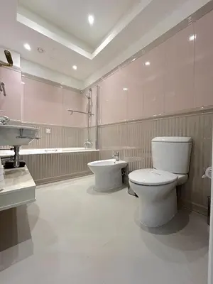 a bathroom with a toilet and a sink at Gulf Beach Apartment by TrulyCyprus in Limassol