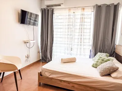 a small bedroom with a bed and a window at Olive studio in Limassol