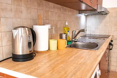a kitchen counter top with a sink and a stove at Olive studio in Limassol