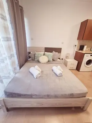 a large bed with two pillows on it in a room at Olive studio in Limassol