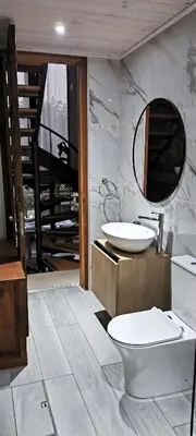 a bathroom with a sink and a toilet and a mirror at The Zephyr House -2- in Pyrgos