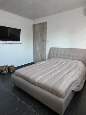a large bed in a room with a tv at Relaxing small home