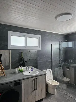 a bathroom with a sink and a toilet at Relaxing small home