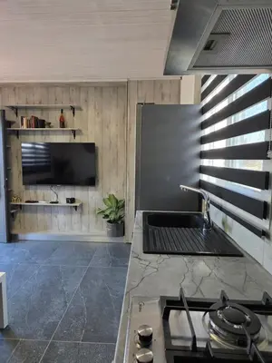 a kitchen with a stove and a counter top at Relaxing small home