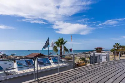 a boardwalk with a view of the beach at Compass 1-Bedroom Apartment in Larnaka
