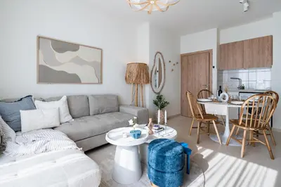 a living room with a couch and a table at Compass 1-Bedroom Apartment in Larnaka