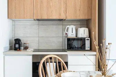 a kitchen with a counter with a microwave at Compass 1-Bedroom Apartment in Larnaka