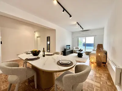 a living room with a dining table and chairs at STAY Aelia Apartment in Nicosia