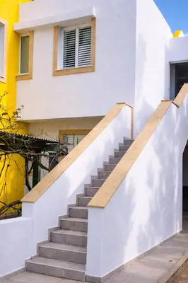 a staircase leading up to a house at Modern Seaside Apartment Steps to the Beach in Pervolia