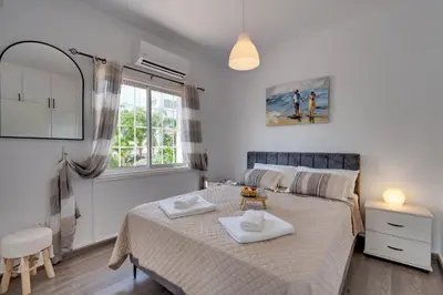 a bedroom with a bed with two towels on it at Oceanic Pearl Villa Deluxe - 200m from beach in Voroklini