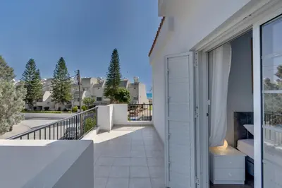 a balcony with a white door and a view at Oceanic Pearl Villa Deluxe - 200m from beach in Voroklini