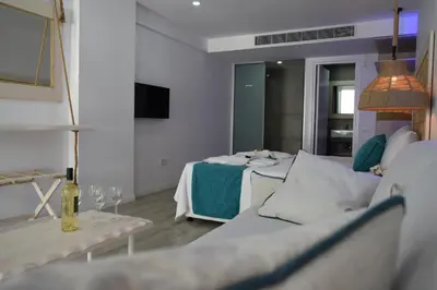 a living room with a couch and a bed at Seaside Stay Room in Ayia Napa