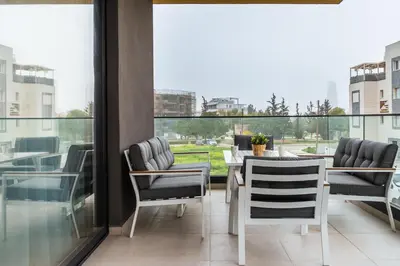 a dining room with a table and chairs on a balcony at Aoki 3-Bedroom Luxury Apartment in Limassol