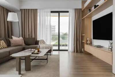 a living room with a couch and a tv at Aoki 3-Bedroom Luxury Apartment in Limassol