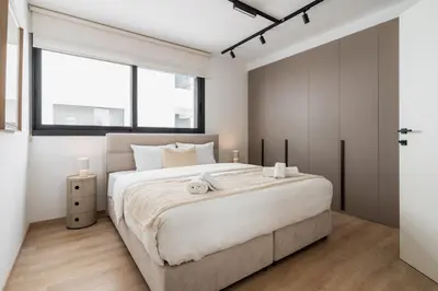 a bedroom with a large white bed and a window at Aoki 3-Bedroom Luxury Apartment in Limassol