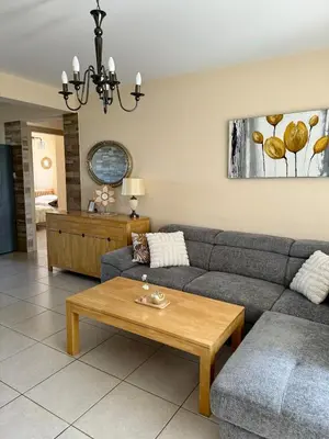 a living room with a couch and a coffee table at NISSI ELENA Family Apt FREE WIFI in Ayia Napa