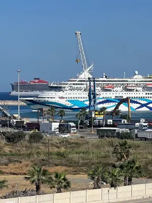 a cruise ship is docked in a harbor at Sea view Appartment in Larnaka