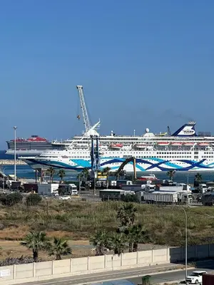 a cruise ship is docked at a harbor at Sea view Appartment in Larnaka