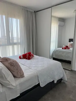 a bedroom with two beds and a large mirror at Sea view Appartment in Larnaka