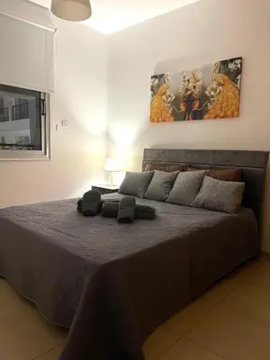 a bedroom with a large bed in a room at Fiori Apartments in Paralimni
