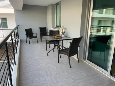 a patio with a table and chairs on a balcony at Fiori Apartments in Paralimni