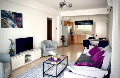 a living room with a couch and a table at Fiori Apartments in Paralimni