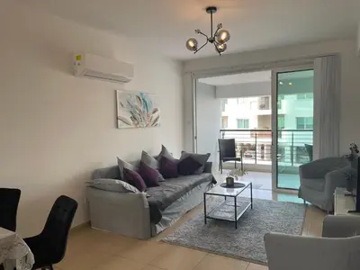 a living room with a couch and a table at Fiori Apartments in Paralimni